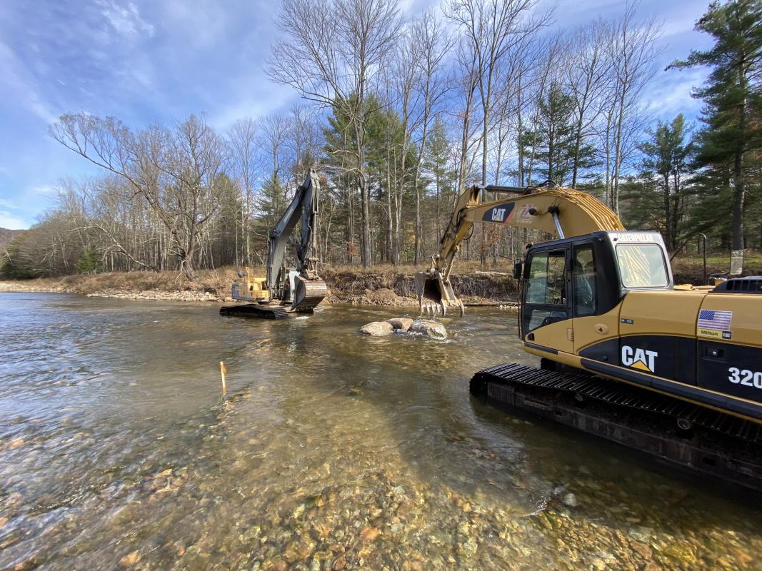 Two machines passing rock reduce bed disturbance