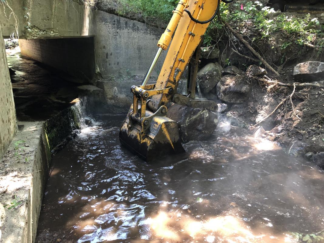 Large boulders fill and stabilize pool