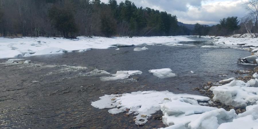 riffle on river with snow along banks